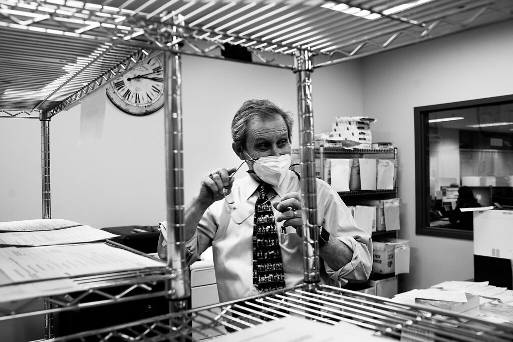 Art Auer laughs at a joke made by a coworker in the early morning of Election Day 2020